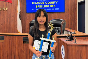 Sydney Tran holds her championship trophy after winning the 2026 Orange County Spelling Bee.
