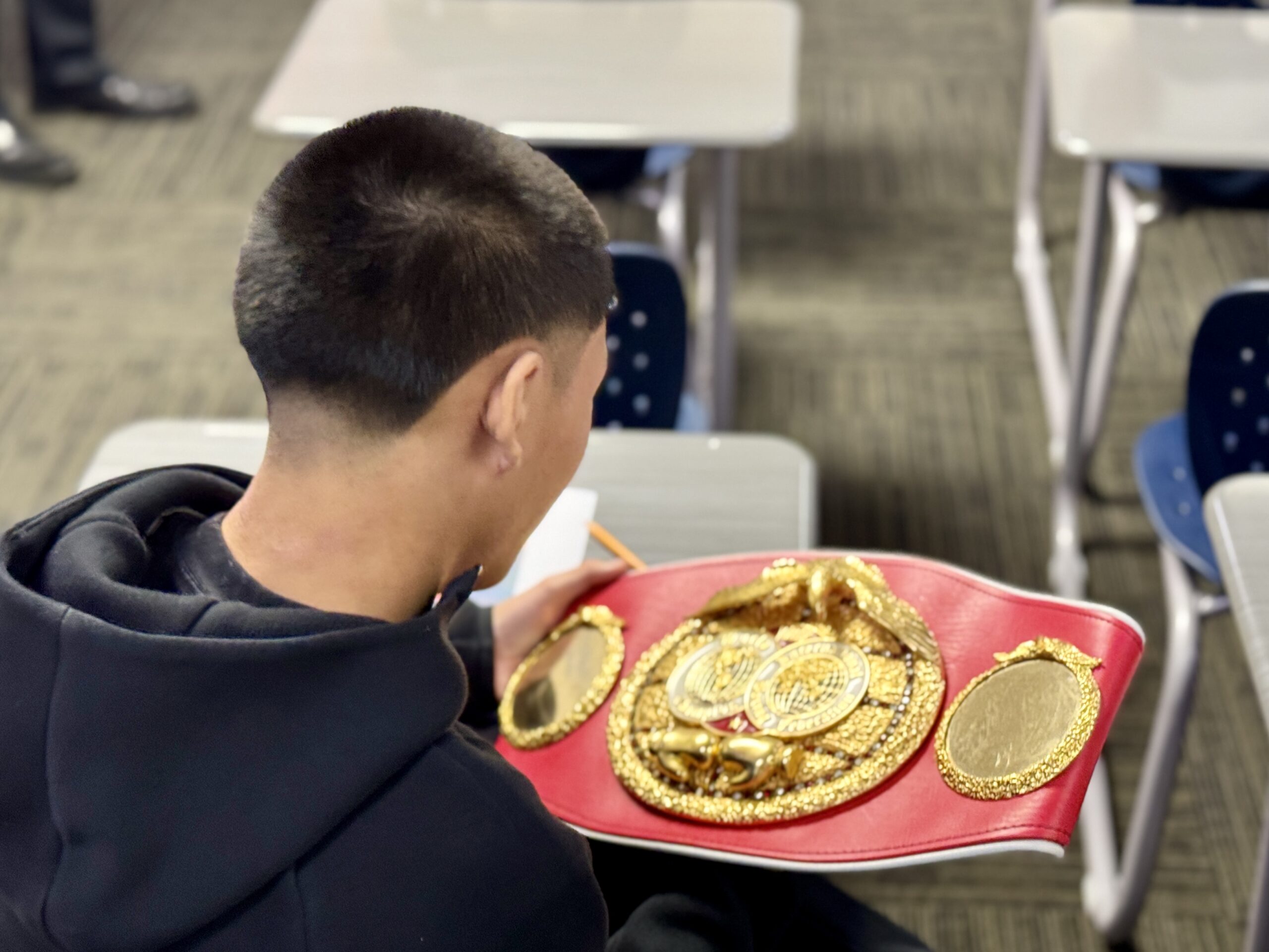 One student taking a closer look at a championship belt.