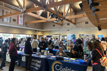 Attendees visit information booths and speak with agency representatives during last year’s countywide transition resource fair, held indoors at the IUSD Learning Center. Tables from community organizations line the room as families gather materials and ask questions about services and employment supports.