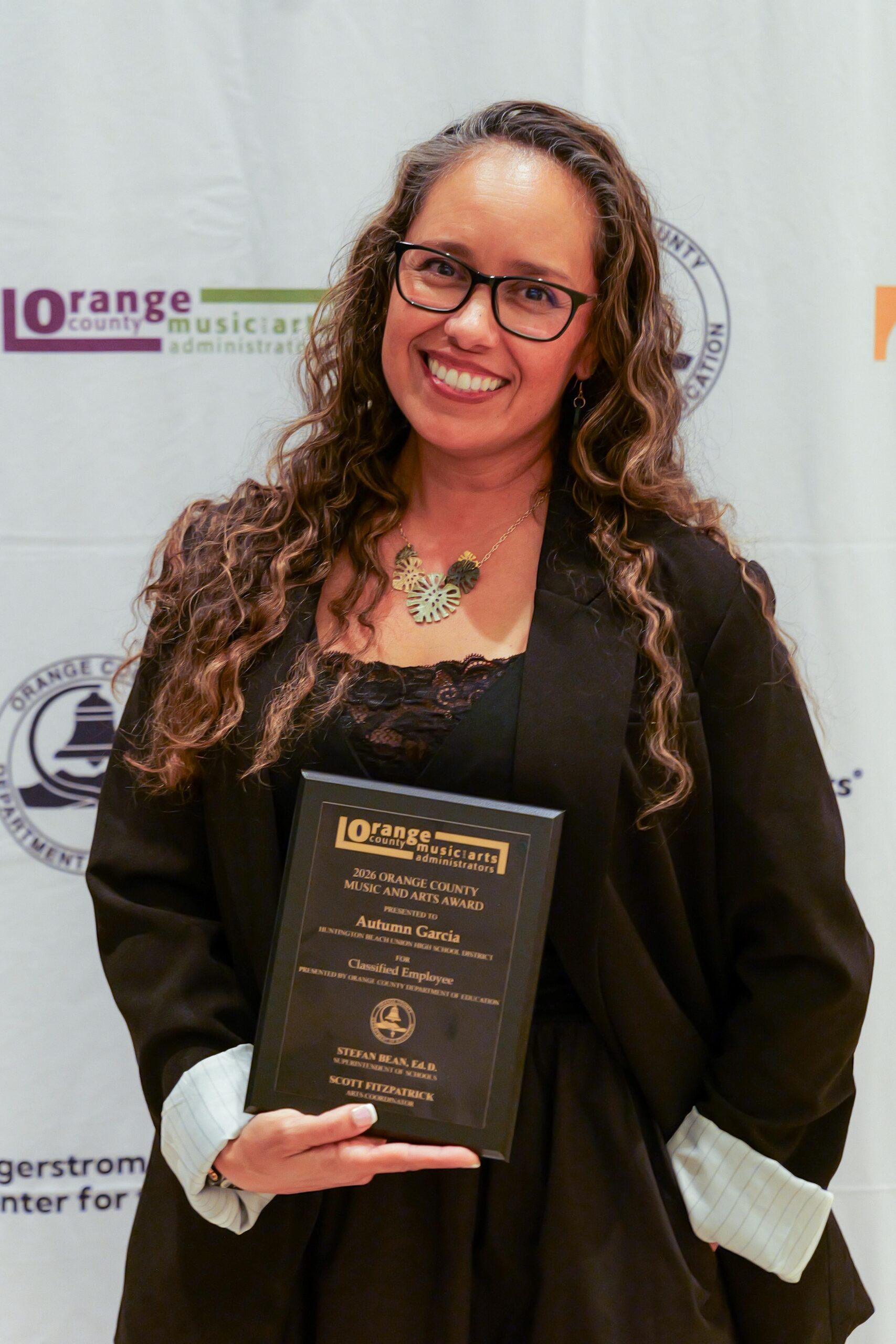 Autumn Garcia of the Huntington Beach Union High School District poses with her award after being recognized as the OCMAA Award recipient for Classified Employee at the 2026 ceremony.