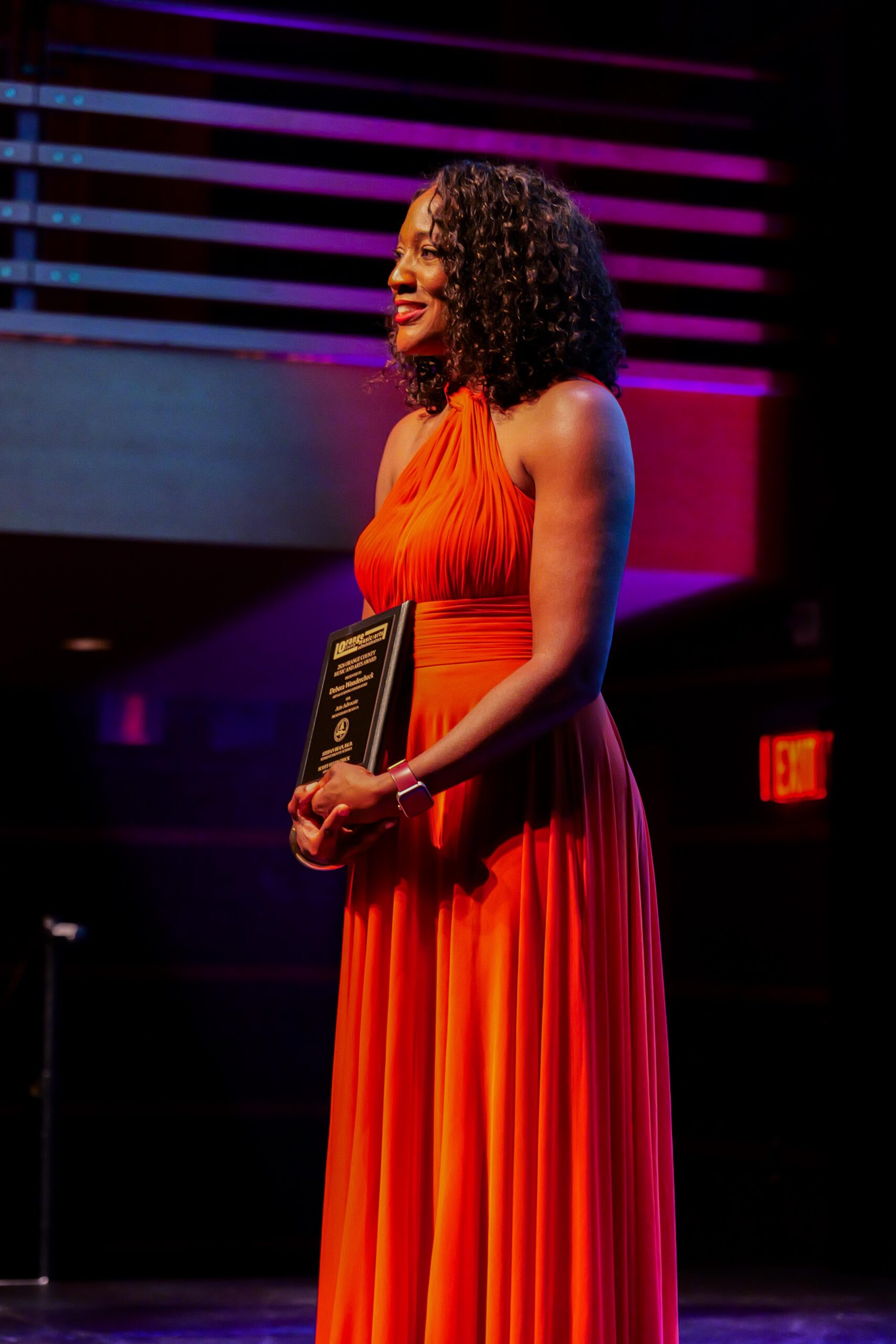 Debora Wondercheck receives her award on stage at the 2026 OCMAA Awards ceremony.