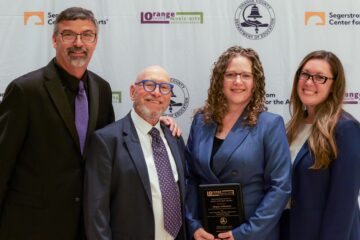 Megan Arthurton of the Placentia-Yorba Linda Unified School District stands with her award after receiving the Irene Schoepfle Lifetime Achievement Award for Music at the 2026 OCMAA Awards.