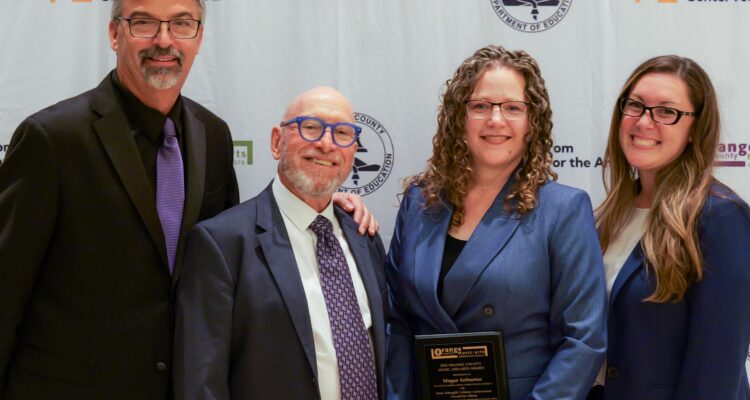 Megan Arthurton of the Placentia-Yorba Linda Unified School District stands with her award after receiving the Irene Schoepfle Lifetime Achievement Award for Music at the 2026 OCMAA Awards.