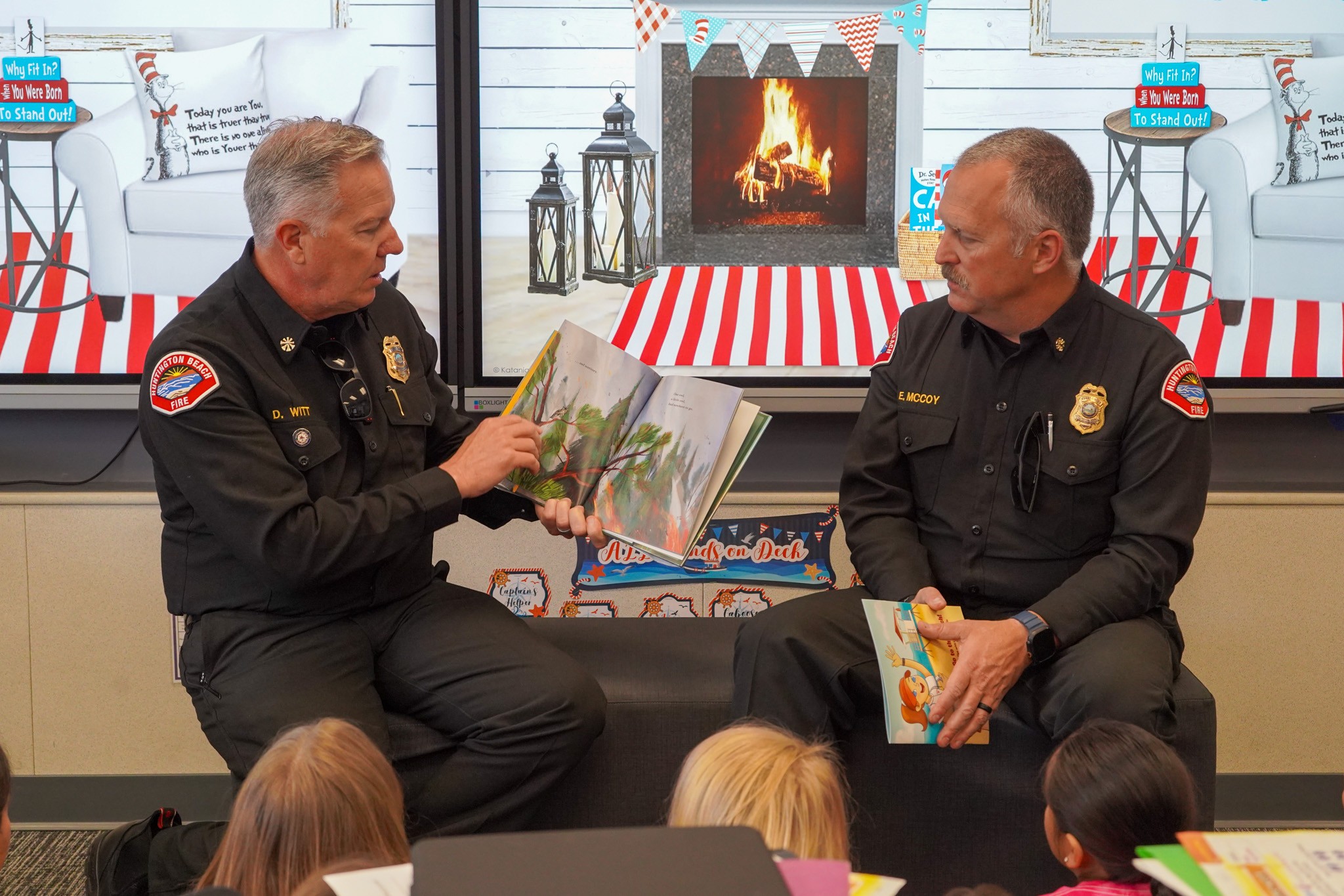 Huntington Beach Fire Department personnel read aloud in a classroom during Read Across America at Peterson Elementary School. 
