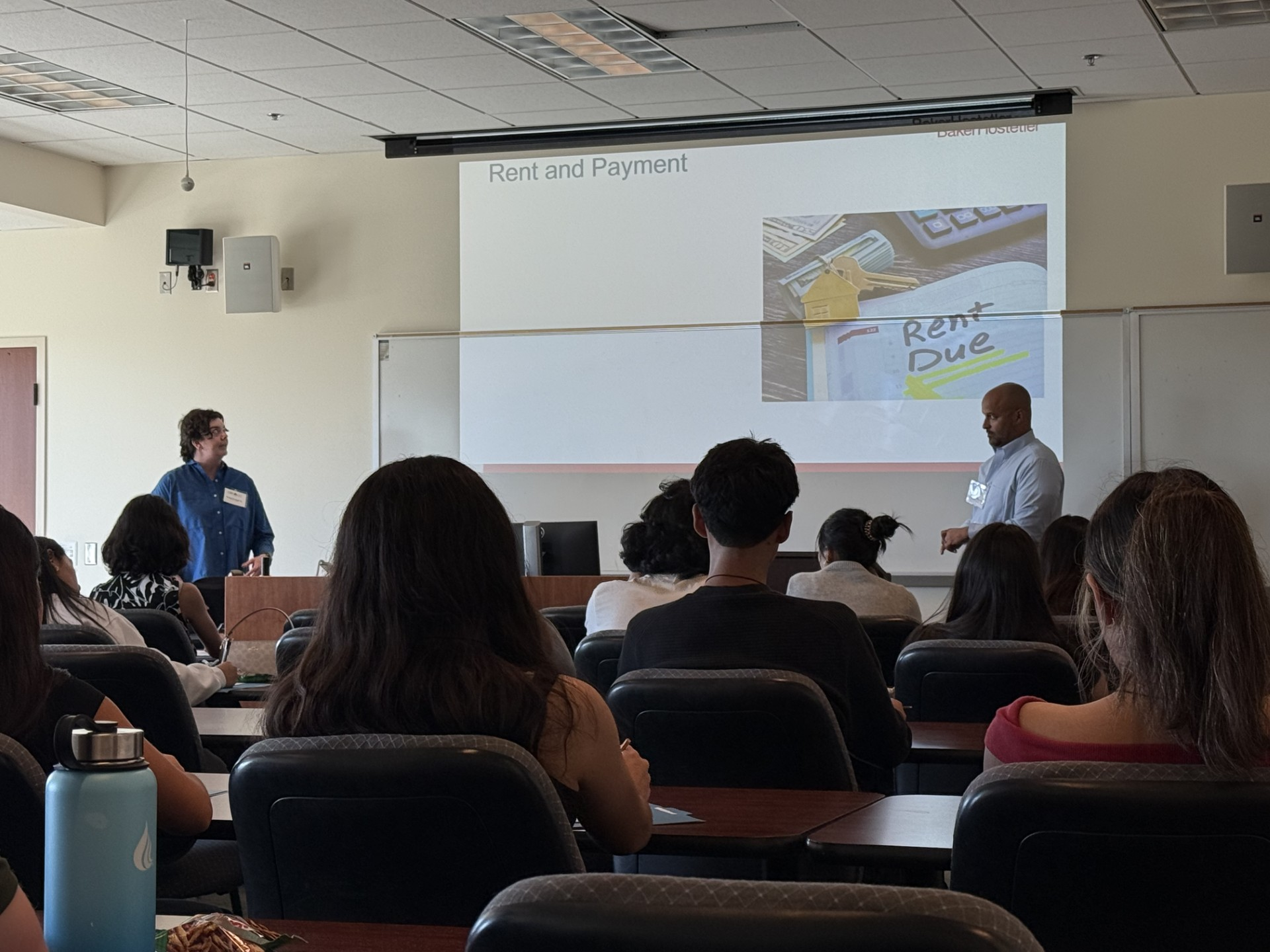 High school students sit in a law school classroom at Chapman University while two presenters lead a workshop on renters’ rights during the Law Day Conference.