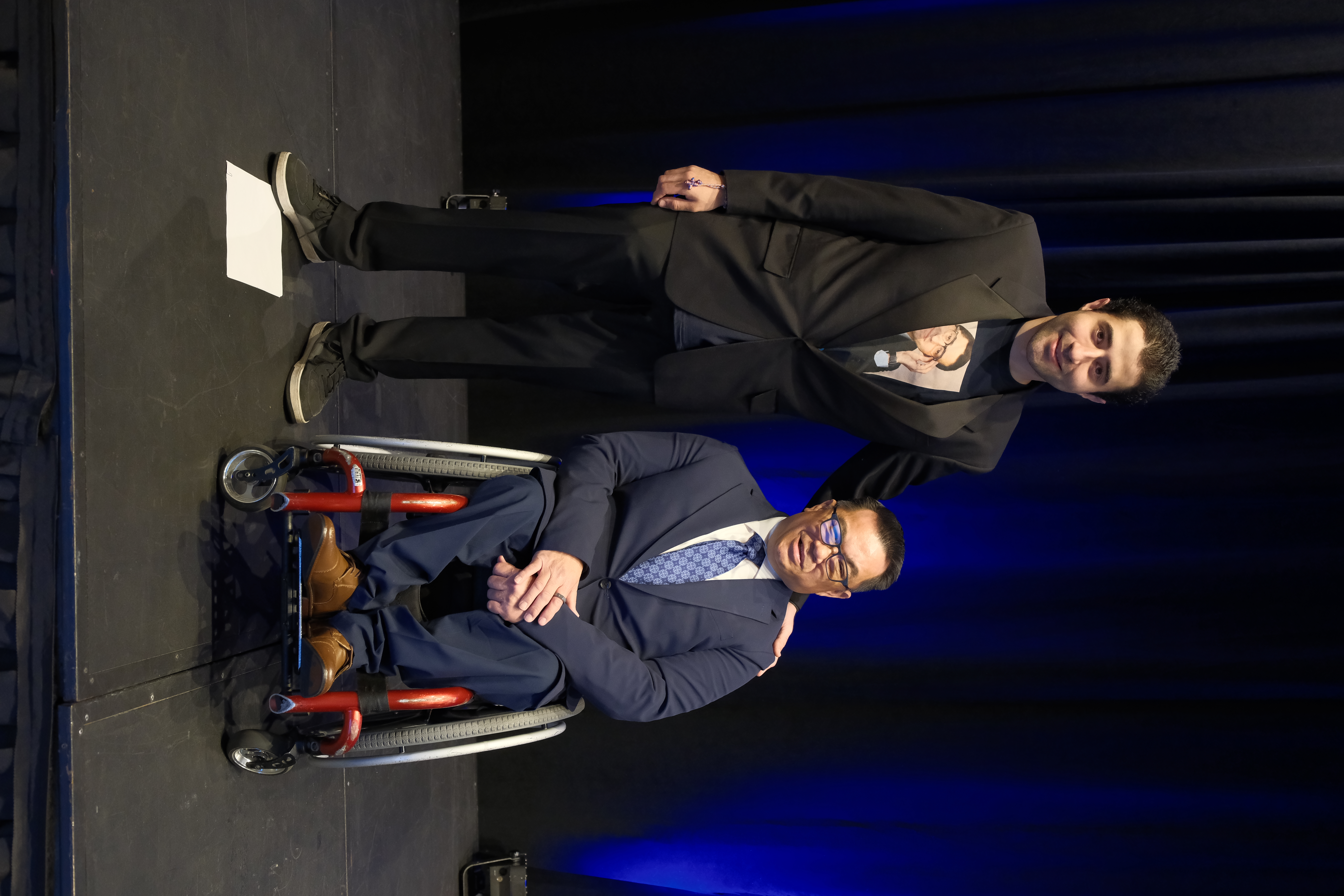 Adán Correa stands beside County Superintendent Dr. Stefan Bean on stage at the Orange County State of Education event.