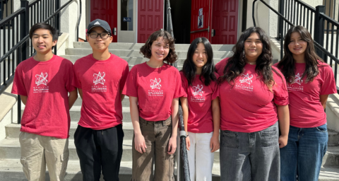 Six students wearing red StellarXplorers shirts stand together for a team photo.