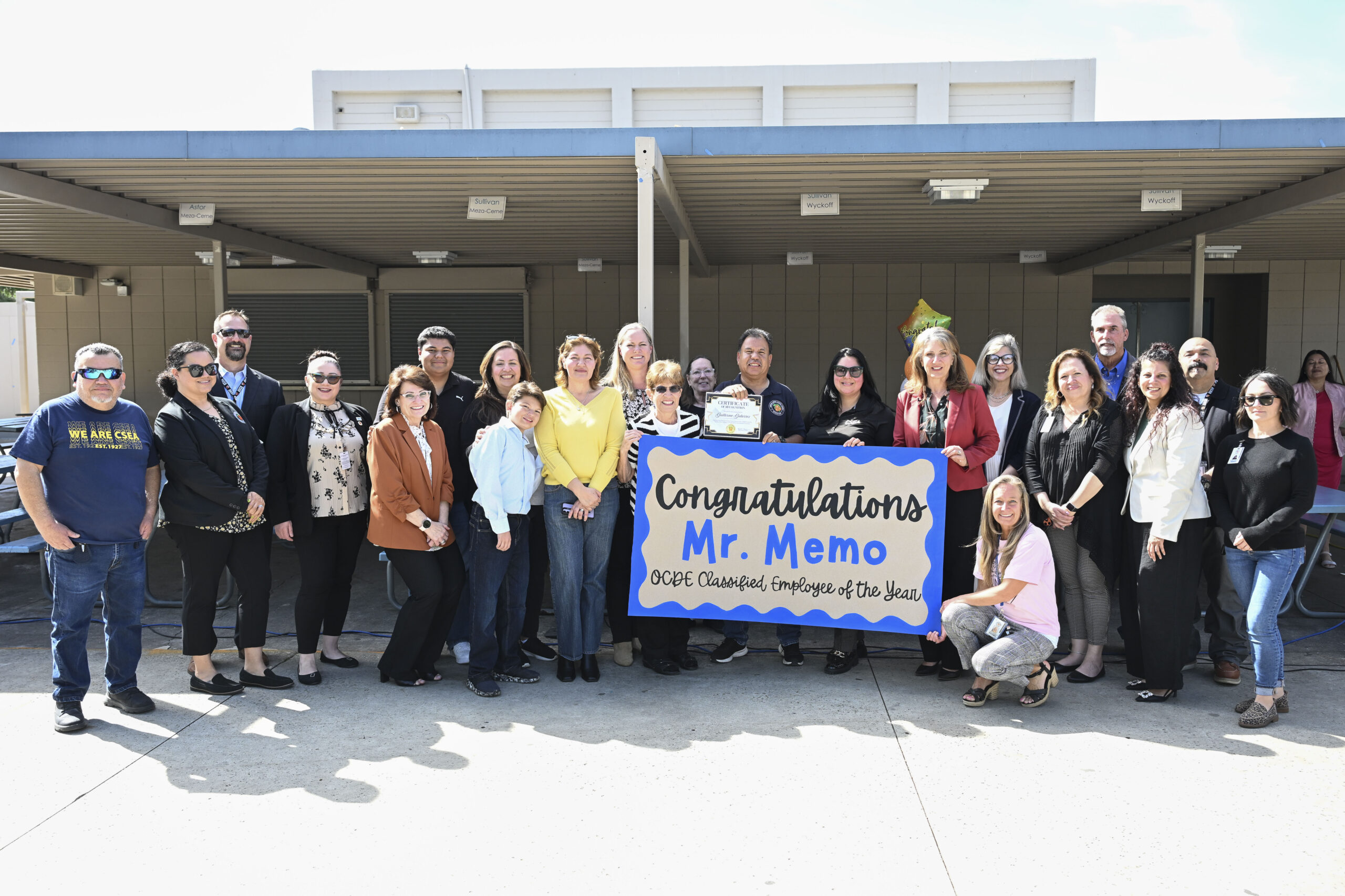 Guillermo “Memo” Gutierrez, custodian at McPherson Magnet School in the Orange Unified School District, stands with colleagues after being named the 2026 Orange County Classified School Employee of the Year in Custodial and Maintenance Services.