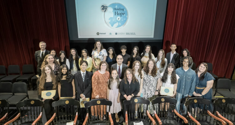 Student winners and their teachers gather on stage with Chapman University President Matt Parlow during the March 13 awards ceremony for the Sala and Aron Samueli Holocaust Art & Writing Contest.
