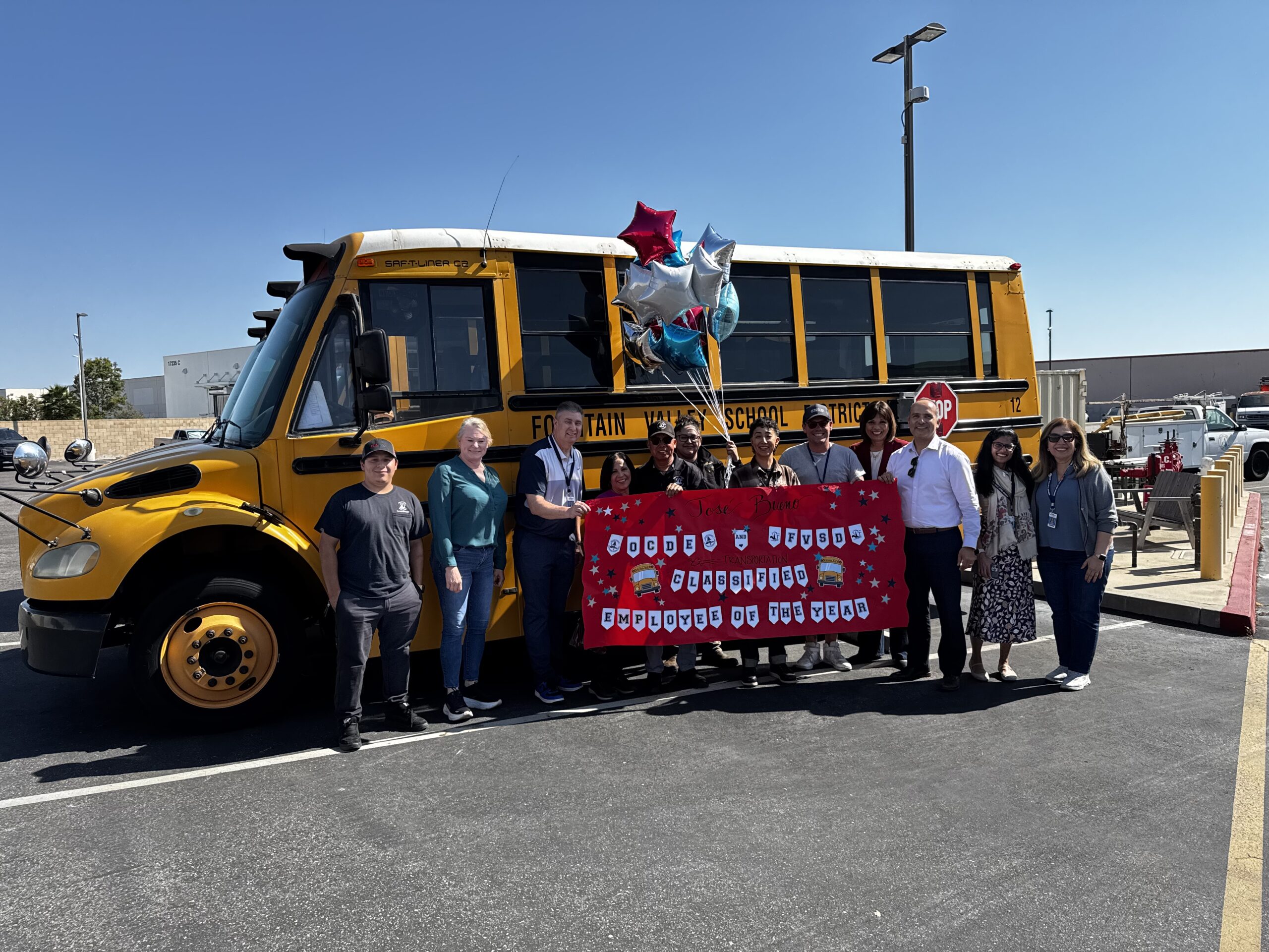 Jose Bueno, bus driver for the Fountain Valley School District, stands with colleagues after being named the 2026 Orange County Classified School Employee of the Year in Transportation Services.