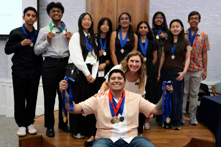 Venado Middle School students pose with their multiple NHD-OC medals alongside teacher and coach Hector Gamboa, and OCDE Coordinator Julie Hull.