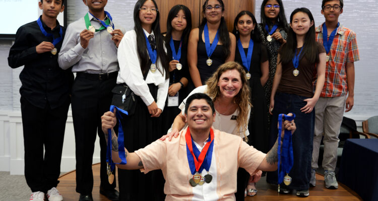 Venado Middle School students pose with their multiple NHD-OC medals alongside teacher and coach Hector Gamboa, and OCDE Coordinator Julie Hull.