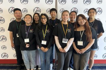 University High School students wearing medals in front of a California Academic Decathlon backdrop.