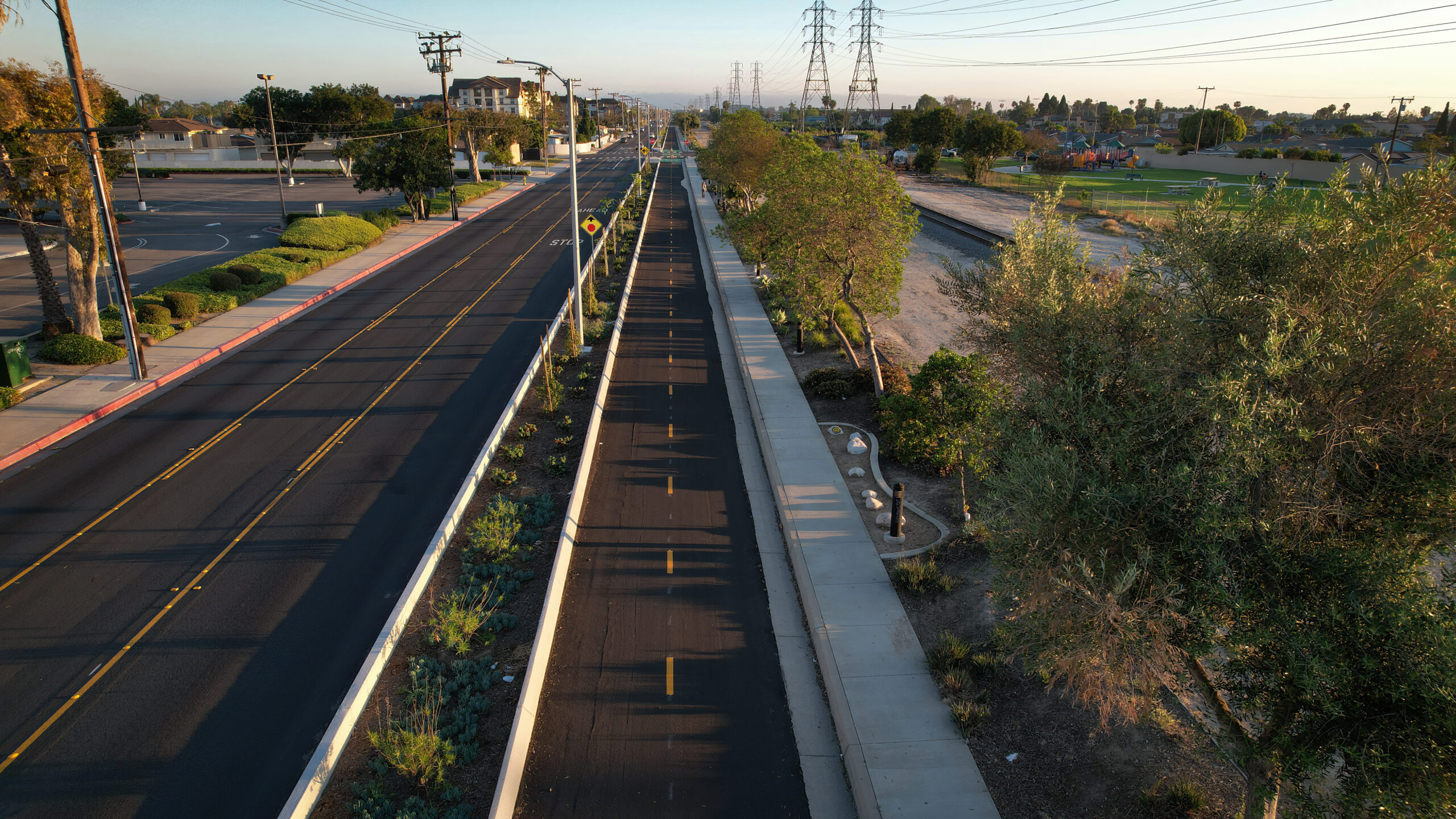 Aerial view of the Mendez Freedom Trail running alongside Hoover Street in Westminster, featuring a protected bikeway and landscaped path.