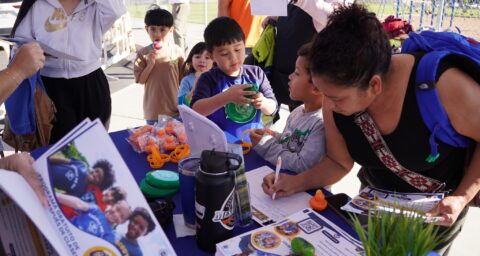 A parent signs up a student for Westminster School District’s new after-school Scouts program during a kickoff event at an elementary school campus.