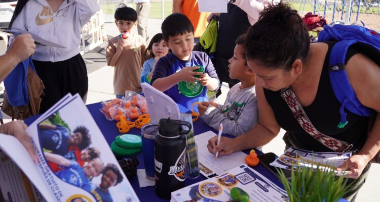 A parent signs up a student for Westminster School District’s new after-school Scouts program during a kickoff event at an elementary school campus.