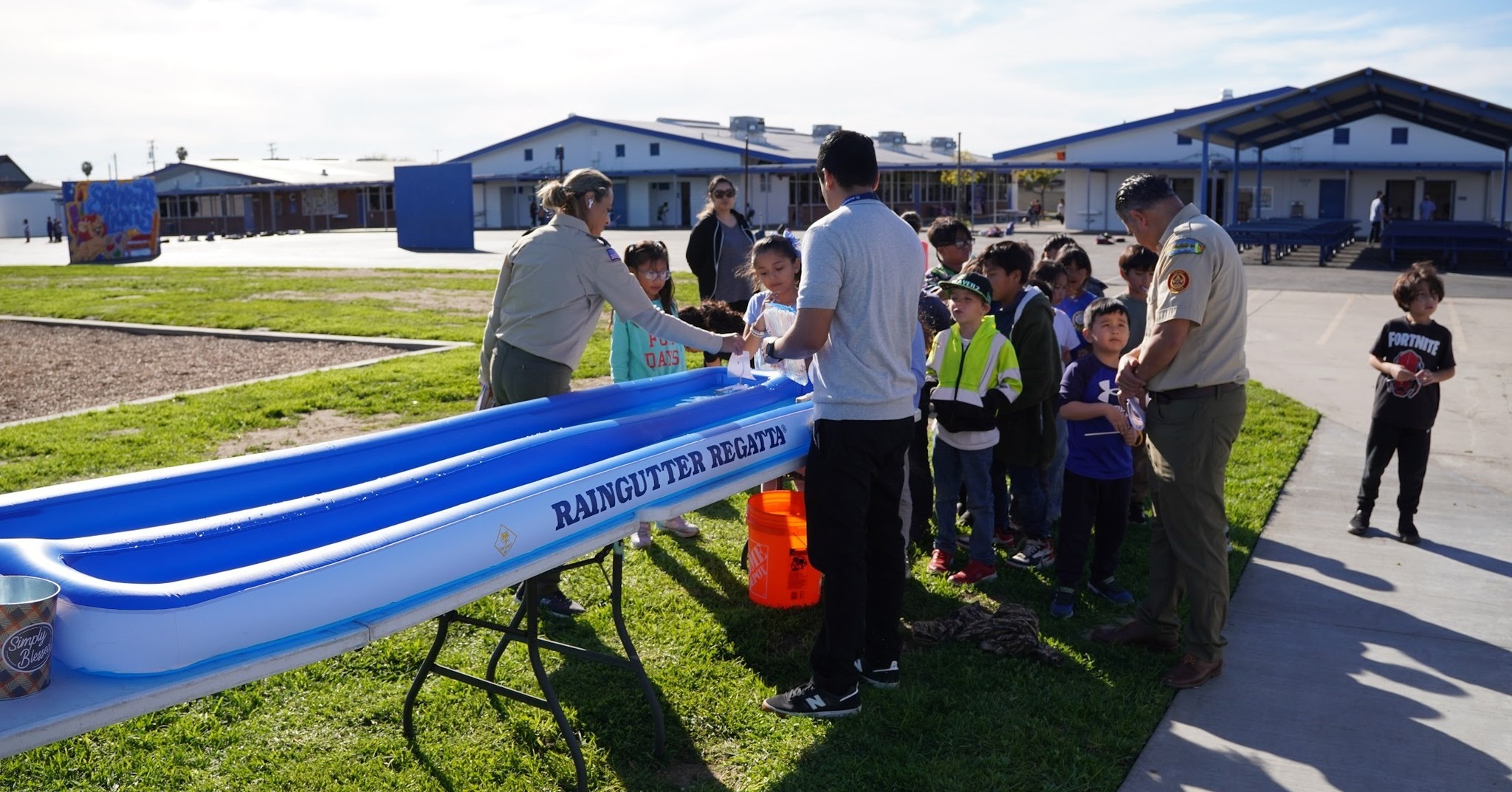 Students participate in a hands-on “rain gutter regatta” activity during a Westminster School District Scouts program kickoff event.
