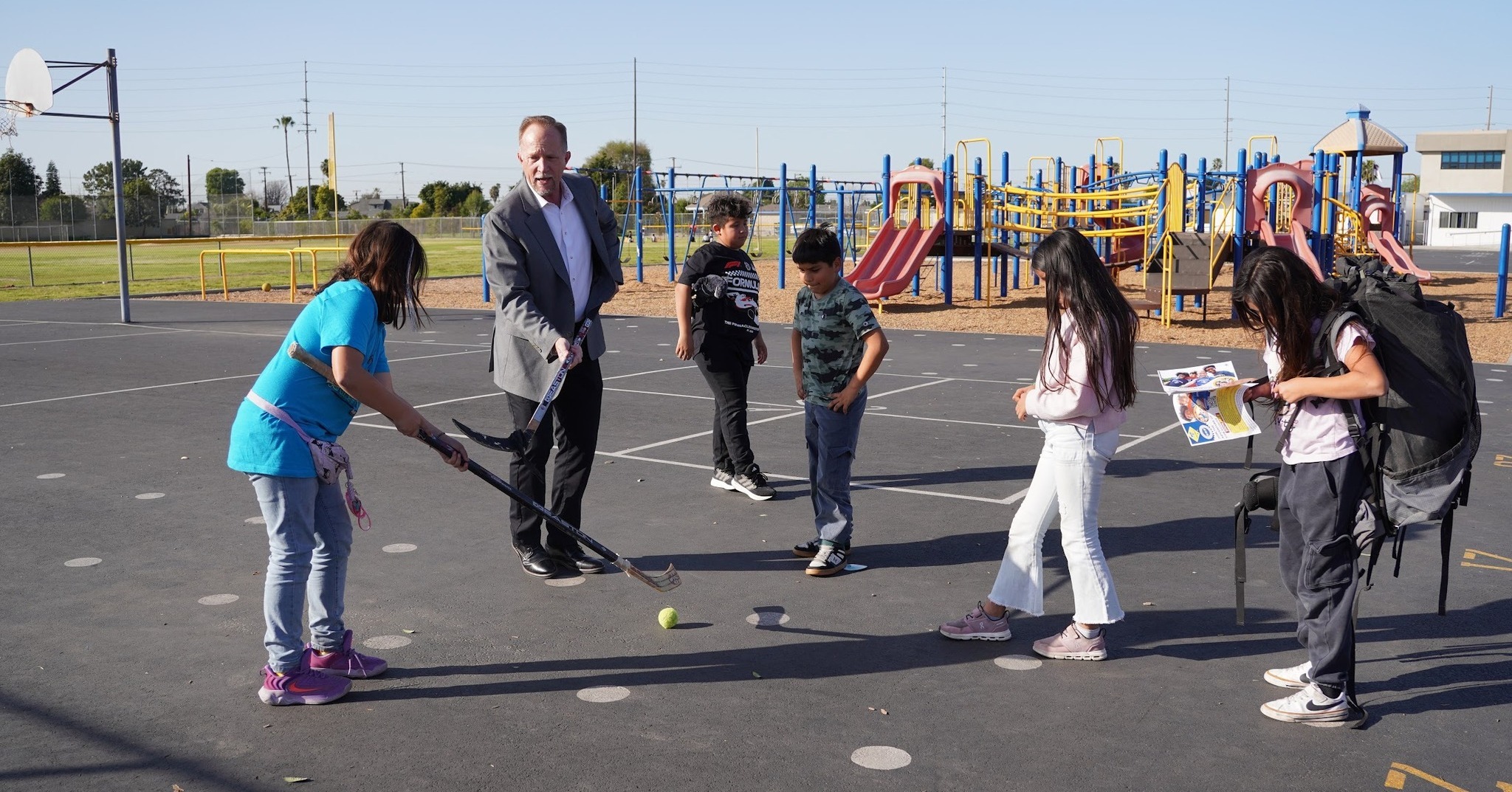 Westminster School District Board of Education Trustee David Johnson, center, joins students during a Scouts program activity on campus.