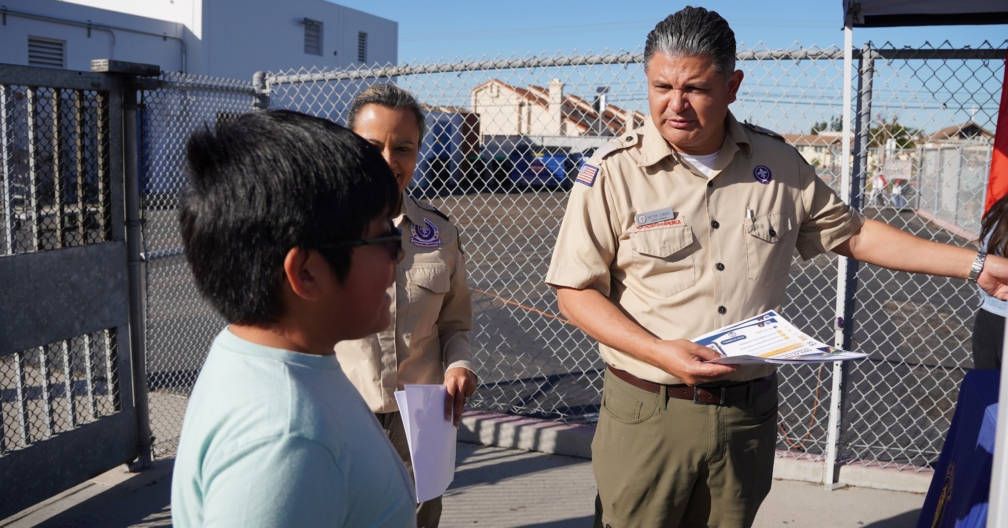 Scouting America volunteers share information about the after-school program with a student during a Westminster School District kickoff event.