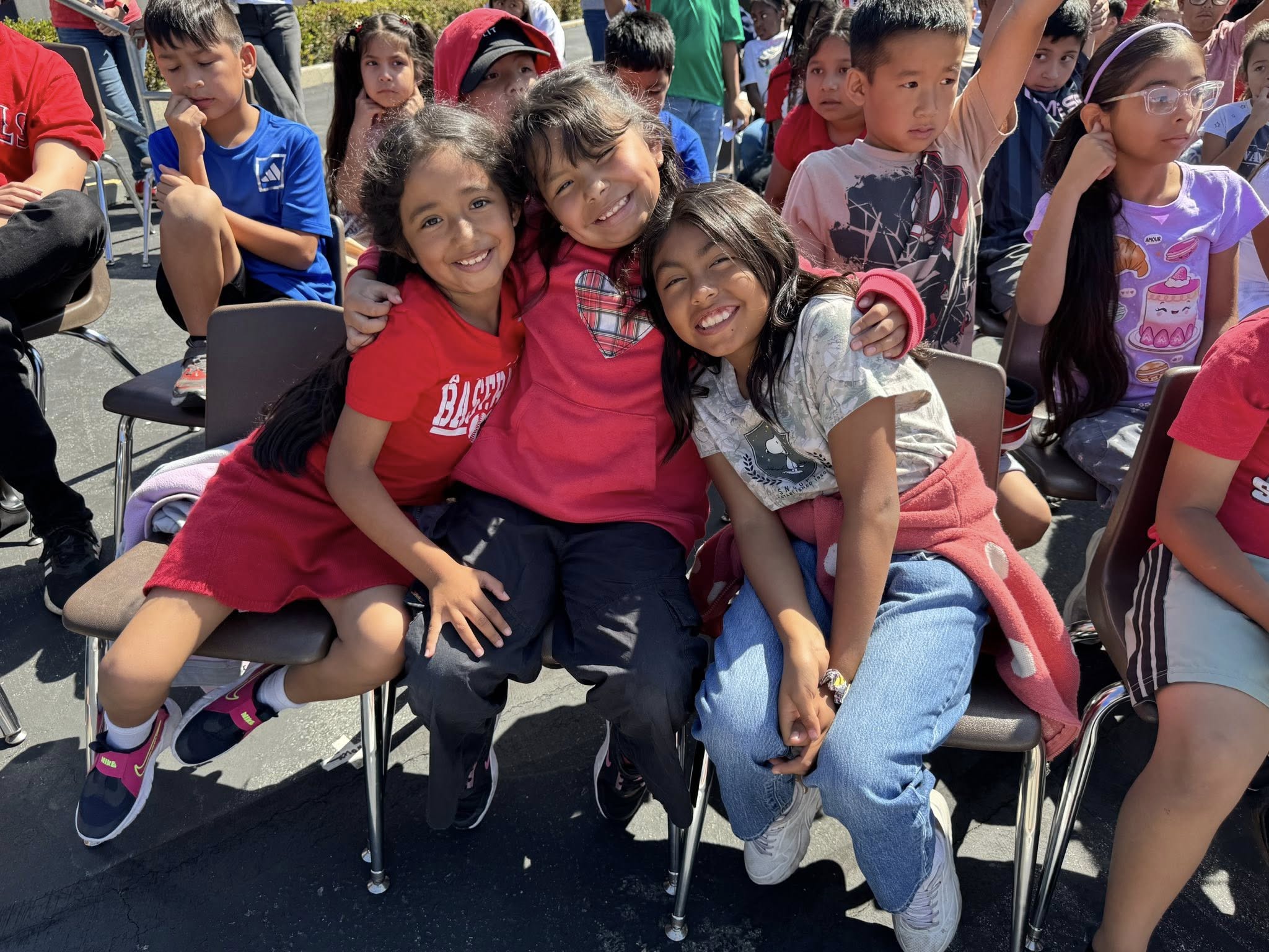 A student smiles while holding a notebook during an Angels Adopt-A-School visit at Gauer Elementary School in Anaheim.