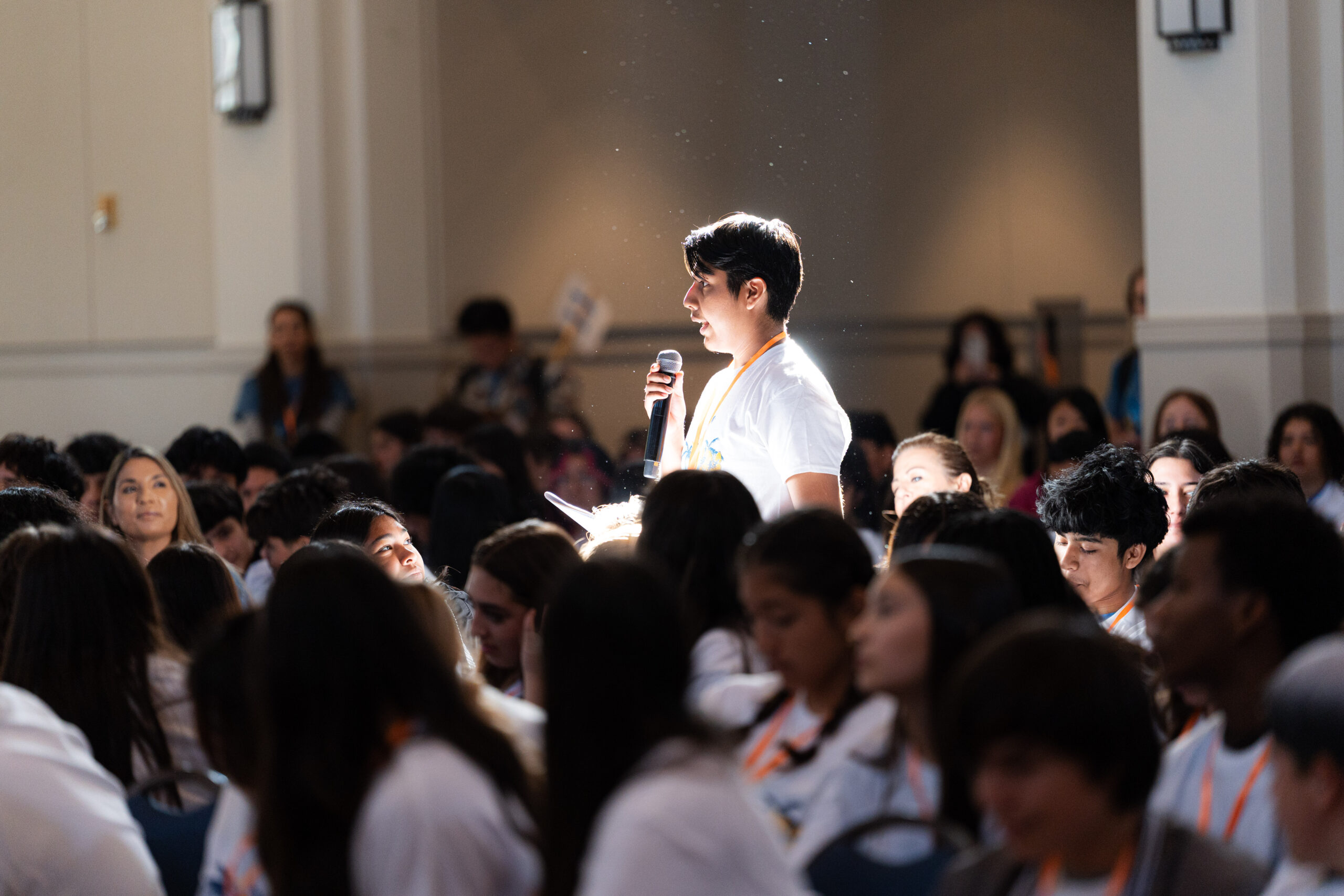 A ninth-grade student asks a question inside Edmunds Ballroom during the AVID 9th Grade Leadership Conference at Pomona College.