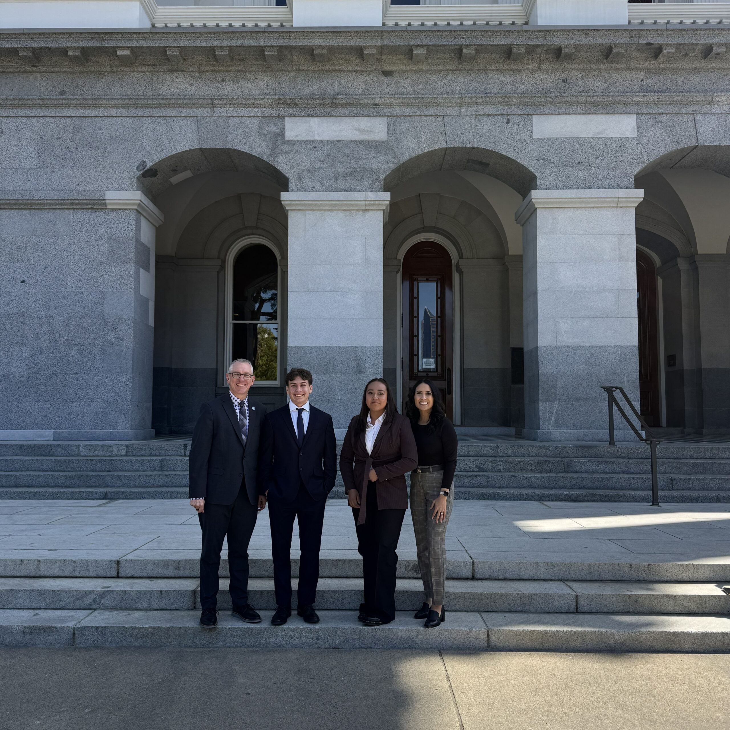 Coastline ROP Superintendent Brian Dozer, left, stands with Laguna Hills High School student Reece Ayala, Estancia High School student Rosselyn Ruiz and Coastline ROP Educational Services Administrator Gina Escobar on the steps of the California State Capitol in Sacramento.