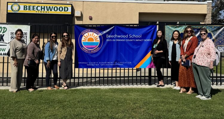 OCDE’s Impact Schools team joins Principal Hannah Lim beside Beechwood School’s banner recognizing its designation as an Impact School.