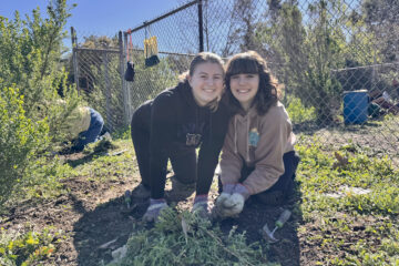Two volunteers take part in a habitat restoration event hosted by OCDE’s Inside the Outdoors program, helping remove invasive plants and support native ecosystems at a regional park.