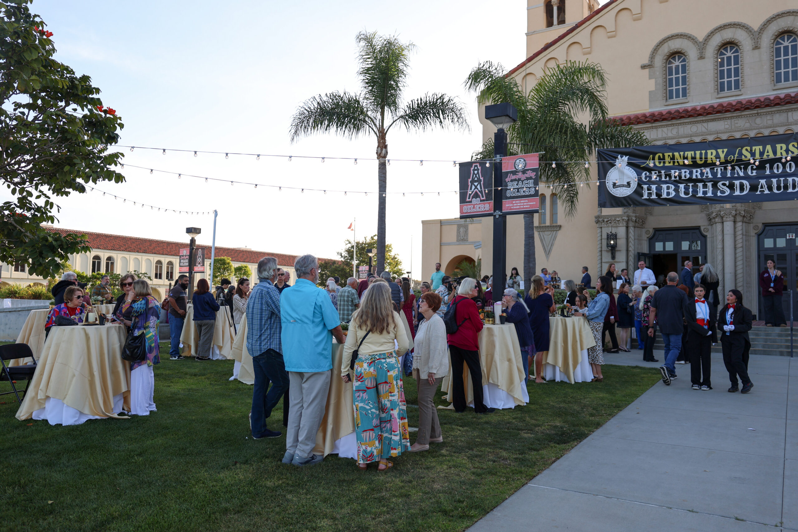 Community members gather outside the Huntington Beach Union High School District auditorium during a 100th anniversary celebration April 20 at Huntington Beach High School.
