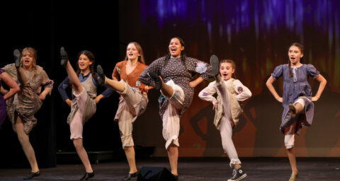 Students perform a high-energy dance number during a program celebrating the 100th anniversary of the Huntington Beach Union High School District auditorium April 20.