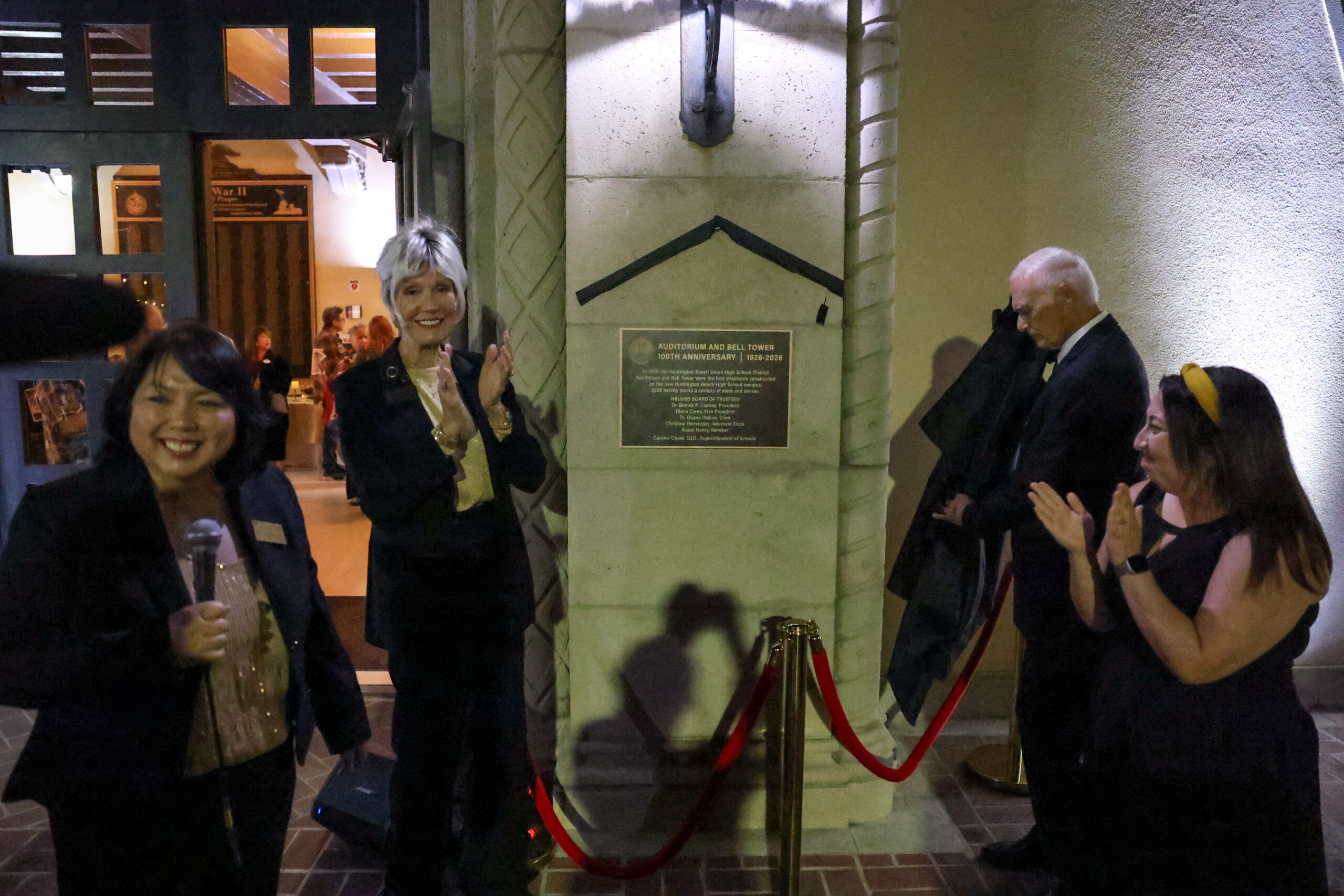 Huntington Beach Union High School District board members applaud as a commemorative plaque is unveiled during a 100th anniversary celebration of the district’s auditorium April 20 at Huntington Beach High School.