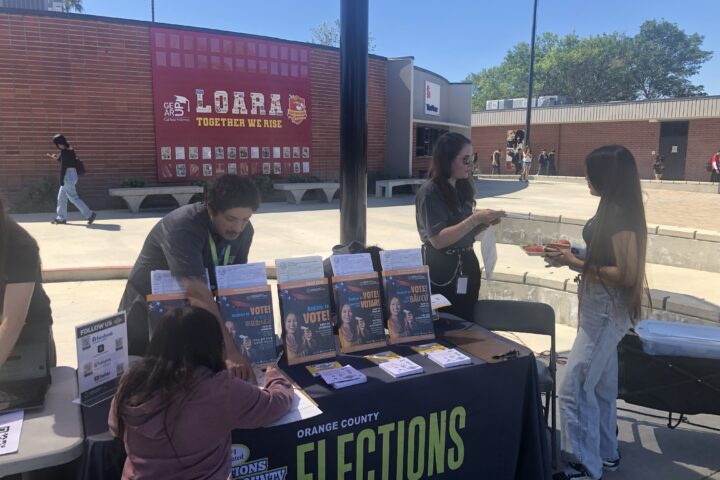 Representatives from the Orange County Registrar of Voters share voter registration information with students at Loara High School in the Anaheim Union High School District on March 12.