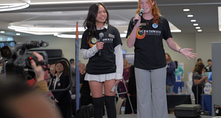 OC Pathways student ambassadors present on stage during the 2023 OC Pathways Showcase, highlighting career education opportunities and student experiences.