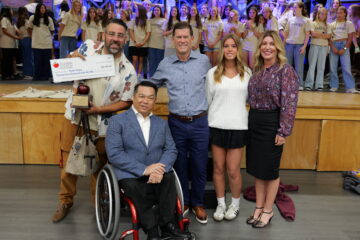 2027 Orange County Teacher of the Year Ryan Healy receives a $25,000 check from the William, Jeff and Jennifer Gross Family Foundation while receiving congratulations from Superintendent Dr. Bean and his Marco Forster Middle School musical theater students.