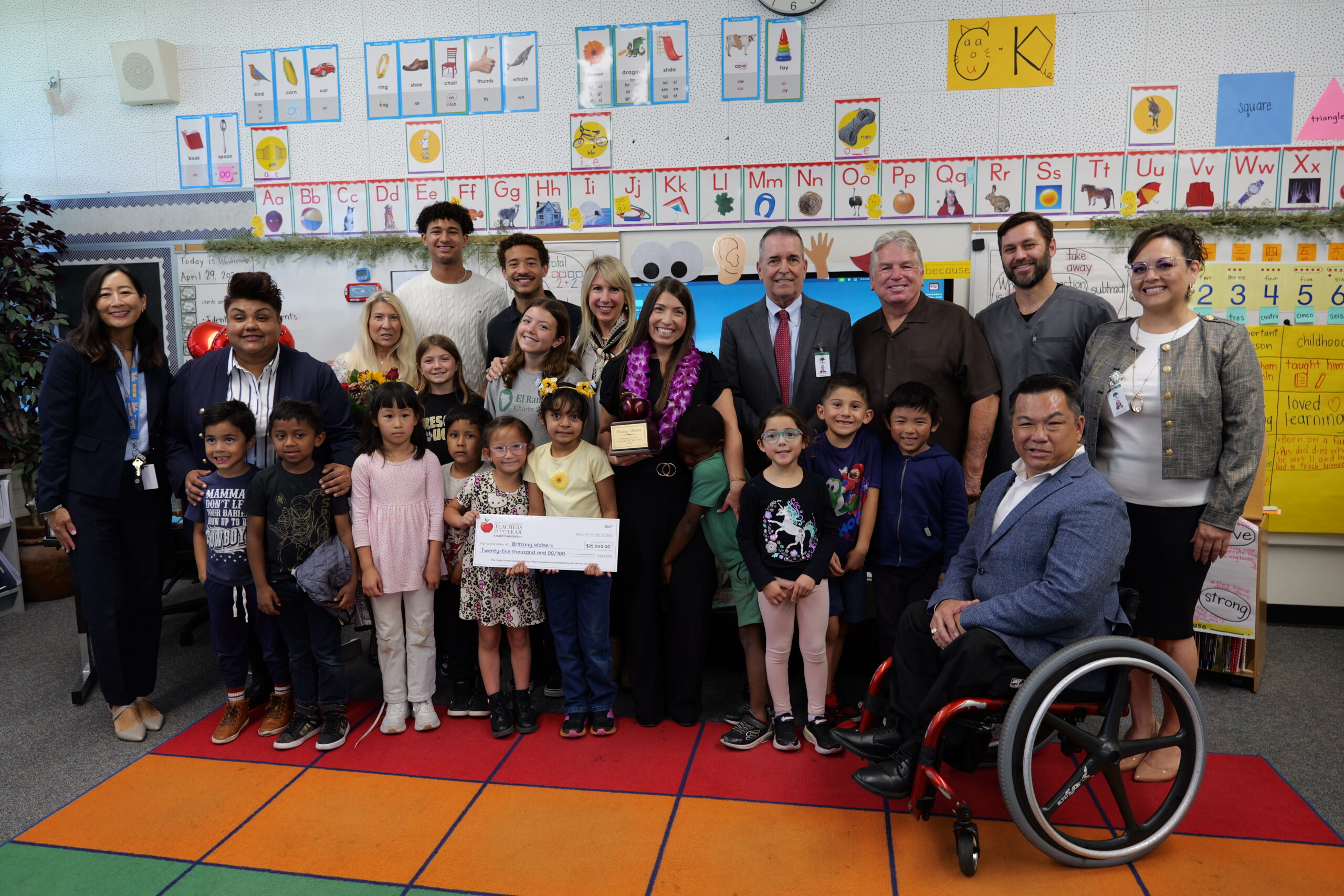 Brittany Walters, a kindergarten teacher at Dr. Peter Marshall Elementary School in the Magnolia School District, is joined by her family, district administrators, Magnolia School District Superintendent Dr. Frank Donavan, Orange County Superintendent of Schools Dr. Stefan Bean and her students after being named a 2027 Orange County Teacher of the Year.