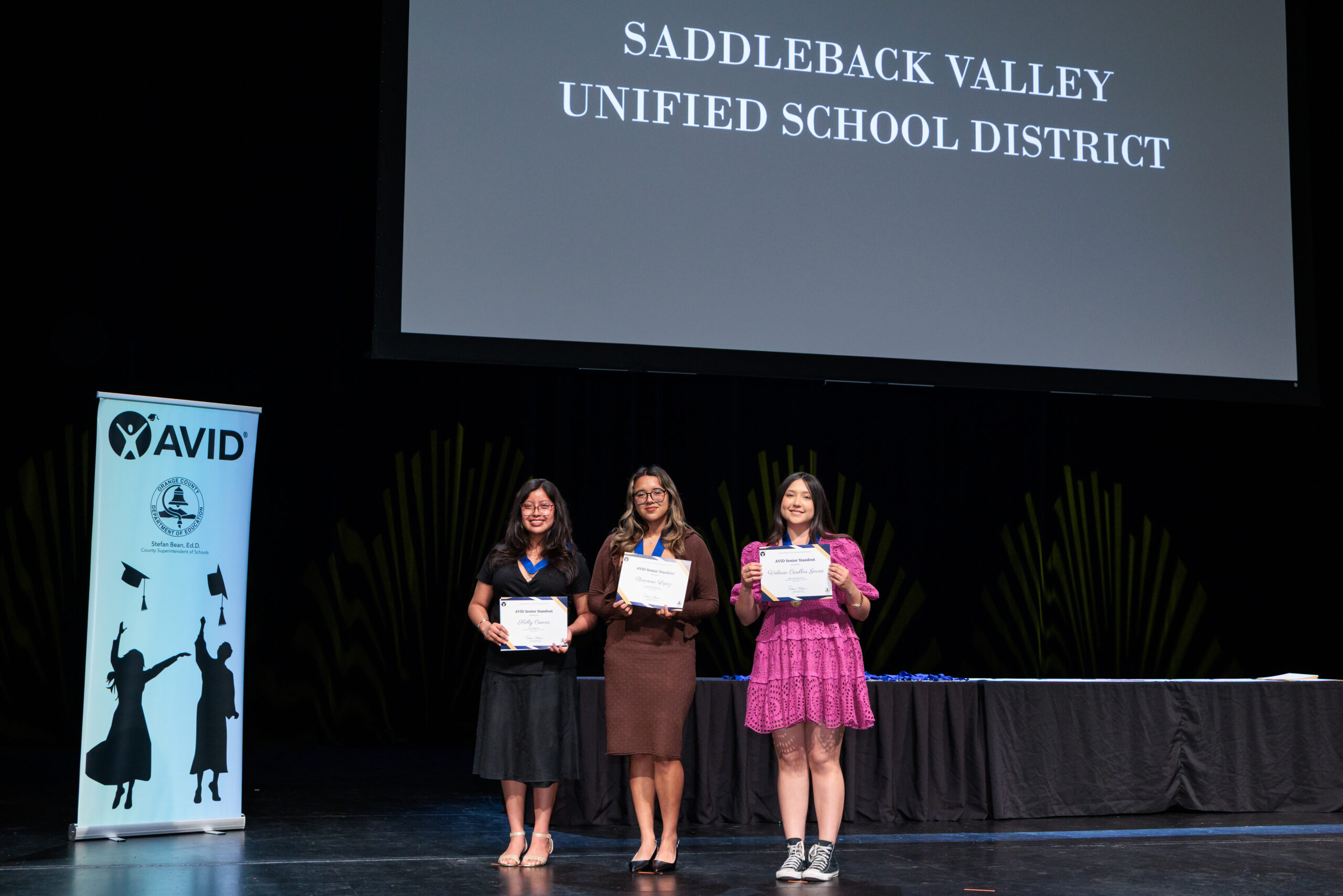 Scholarship recipients stand on stage during the 2026 OC AVID Senior Standout Recognition and Scholarship Presentation held April 15 at the Irvine Barclay Theatre.