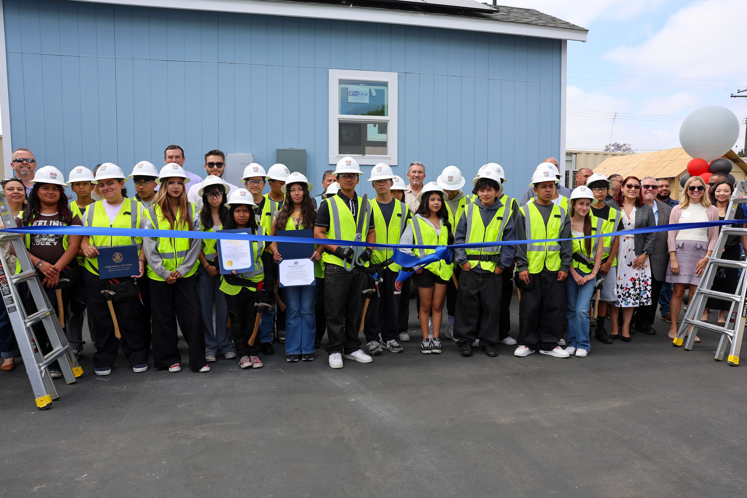 Fullerton School District officials, educators, community partners and students celebrate the unveiling of the third addition to the tiny home project on May 22. (Courtesy of Fullerton School District)