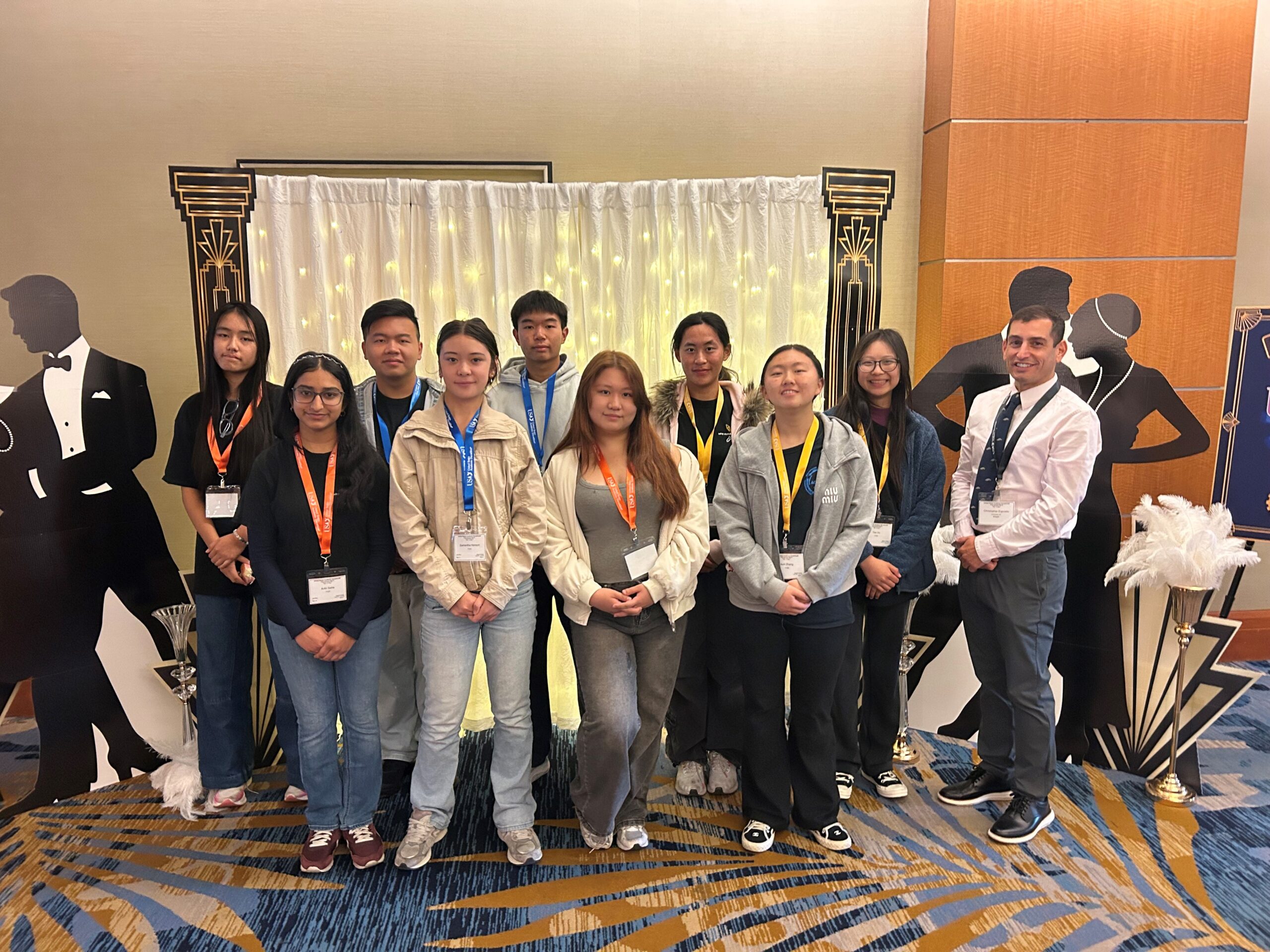 University High School’s Academic Decathlon team and coach Christopher Esposito pose during the 2026 United States Academic Decathlon National Competition, which featured the theme “The Roaring Twenties.”