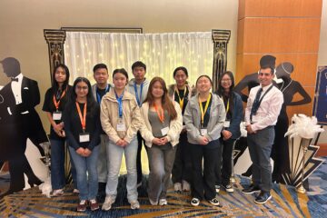 University High School’s Academic Decathlon team and coach Christopher Esposito pose during the 2026 United States Academic Decathlon National Competition, which featured the theme “The Roaring Twenties.”