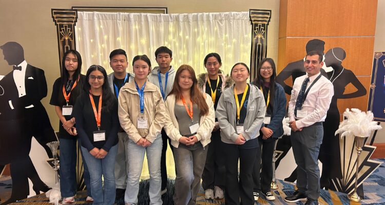 University High School’s Academic Decathlon team and coach Christopher Esposito pose during the 2026 United States Academic Decathlon National Competition, which featured the theme “The Roaring Twenties.”