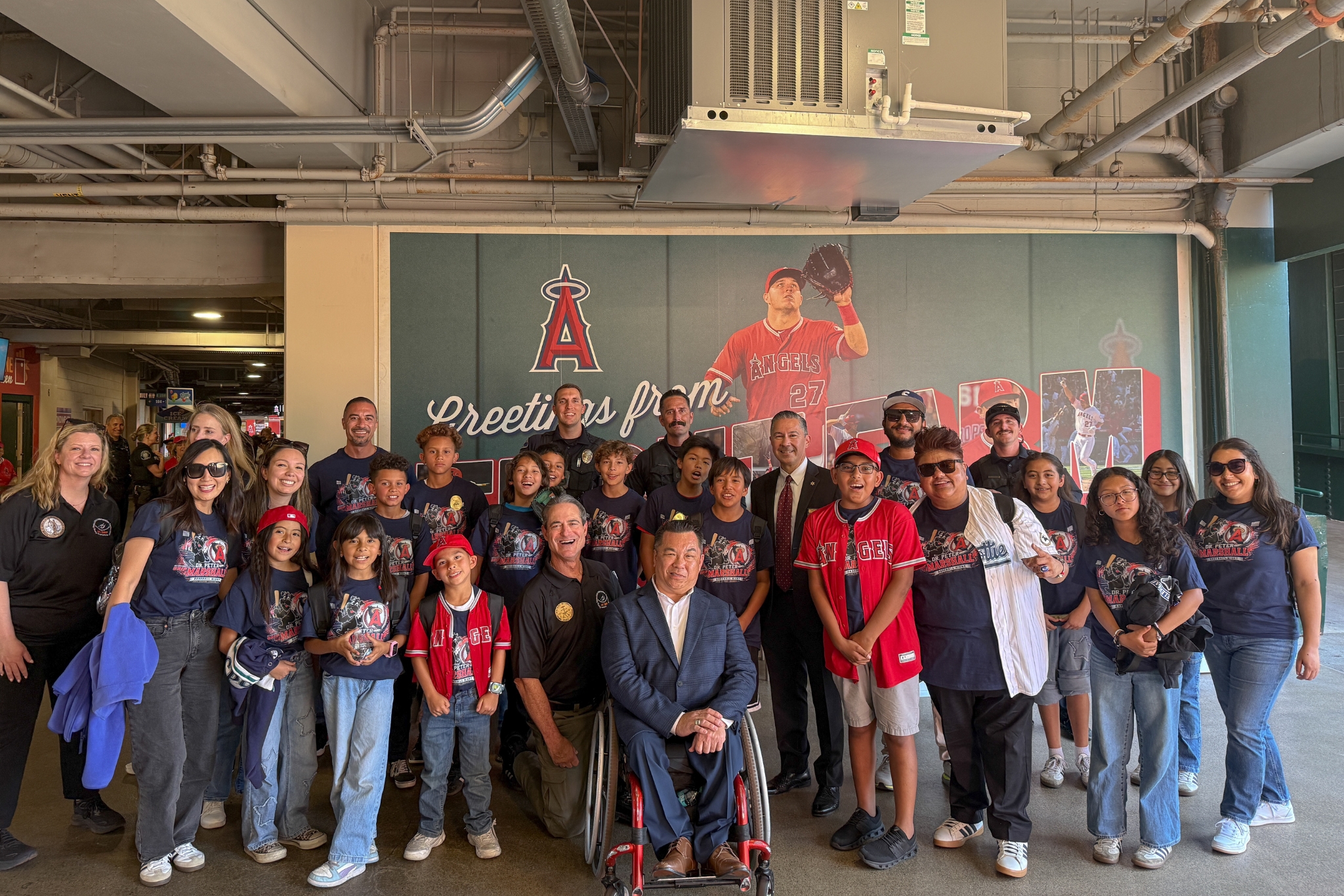 Orange County Superintendent of Schools Dr. Stefan Bean, Orange County District Attorney Todd Spitzer, OC GRIP representatives, students and school staff pose for a photo during a mentorship event at Angel Stadium on May 19.