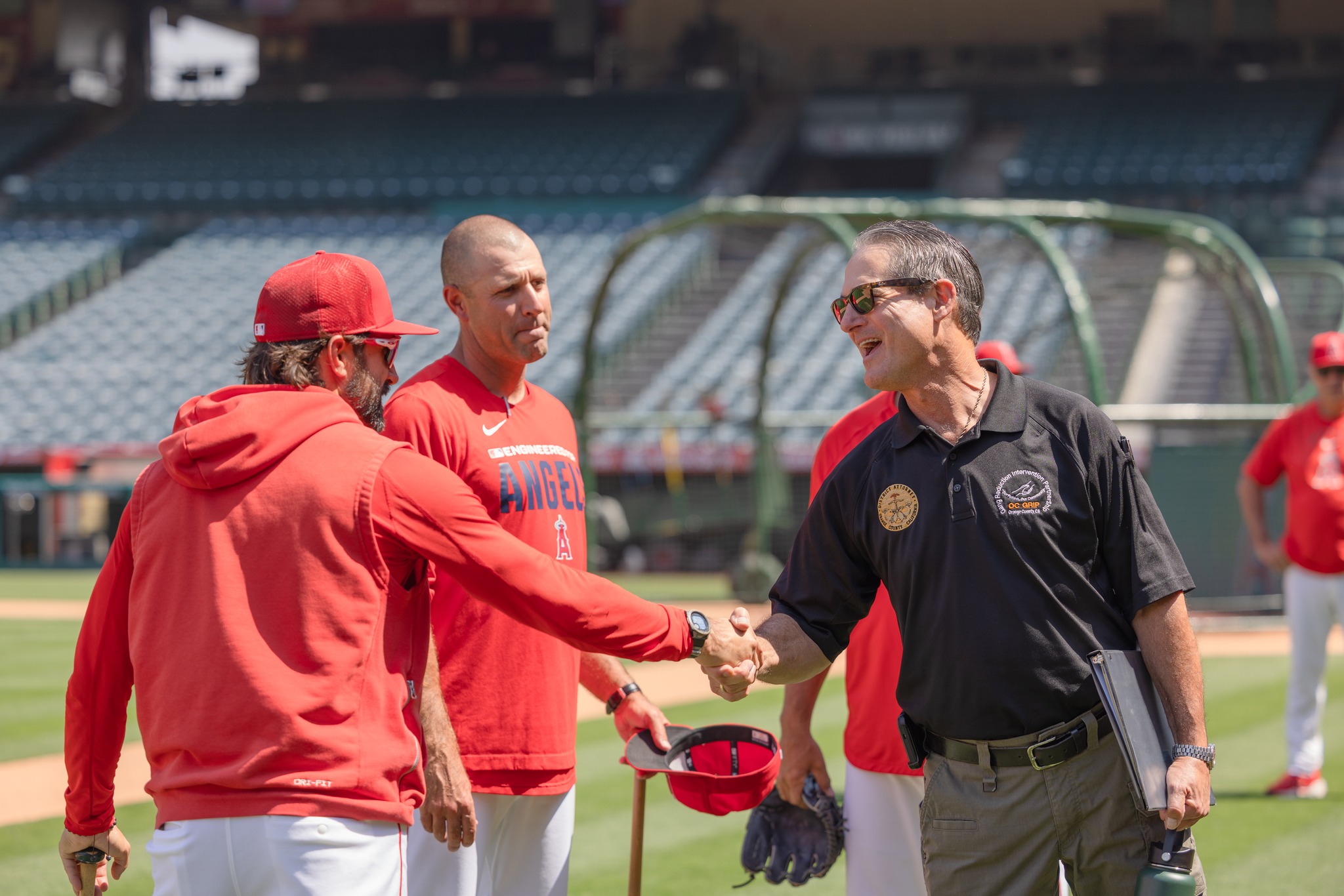 Orange County District Attorney Todd Spitzer greets Los Angeles Angels players before a mentorship event for students participating in the OC GRIP program at Angel Stadium on May 19.