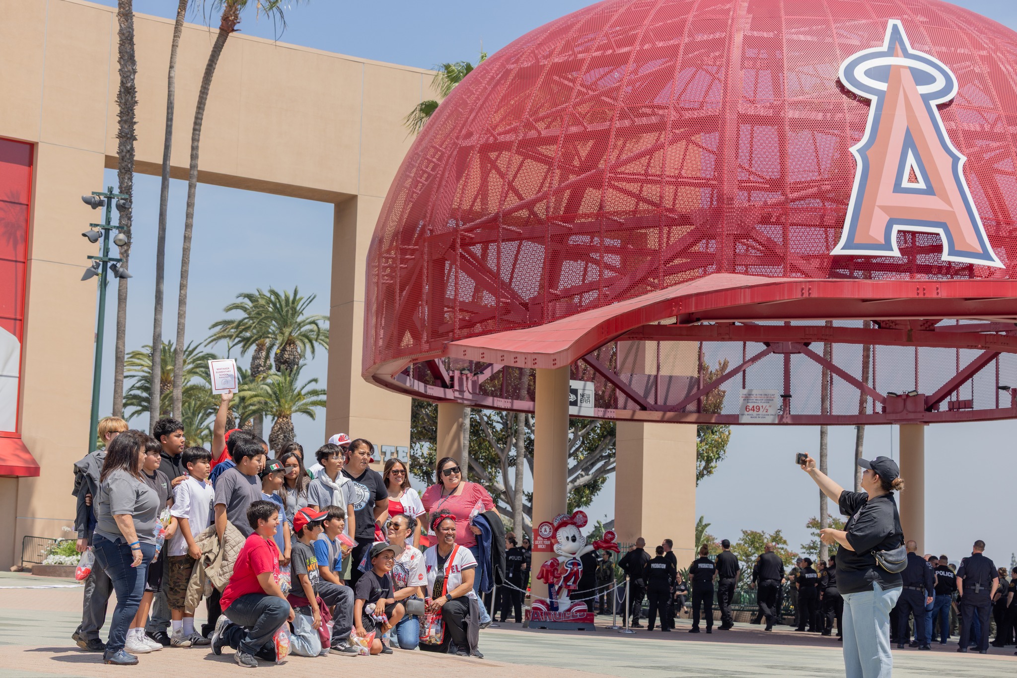 Students participating in the OC GRIP program pose for a photo outside Angel Stadium before the Los Angeles Angels’ May 19 game against the Oakland Athletics.