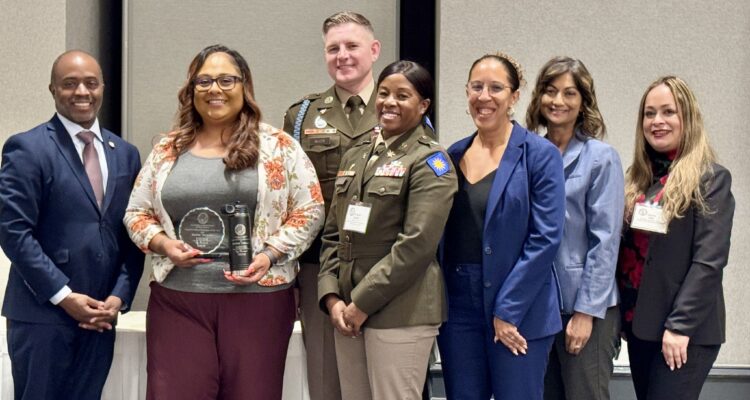 From left, State Superintendent of Public Instruction Tony Thurmond, Raelene Velasquez, Command Sgt. Maj. Richard Aller, Sunburst Youth Academy Director Lt. Col. Sarah Rambo, Principal Dinah Ismail, OCDE Executive Director of Special Education Dr. Amita Cloke and OCDE Manager of Human Resources Support Services Lorena Villa pose for a photo during the 2026 California Classified School Employees of the Year recognition ceremony in Sacramento.