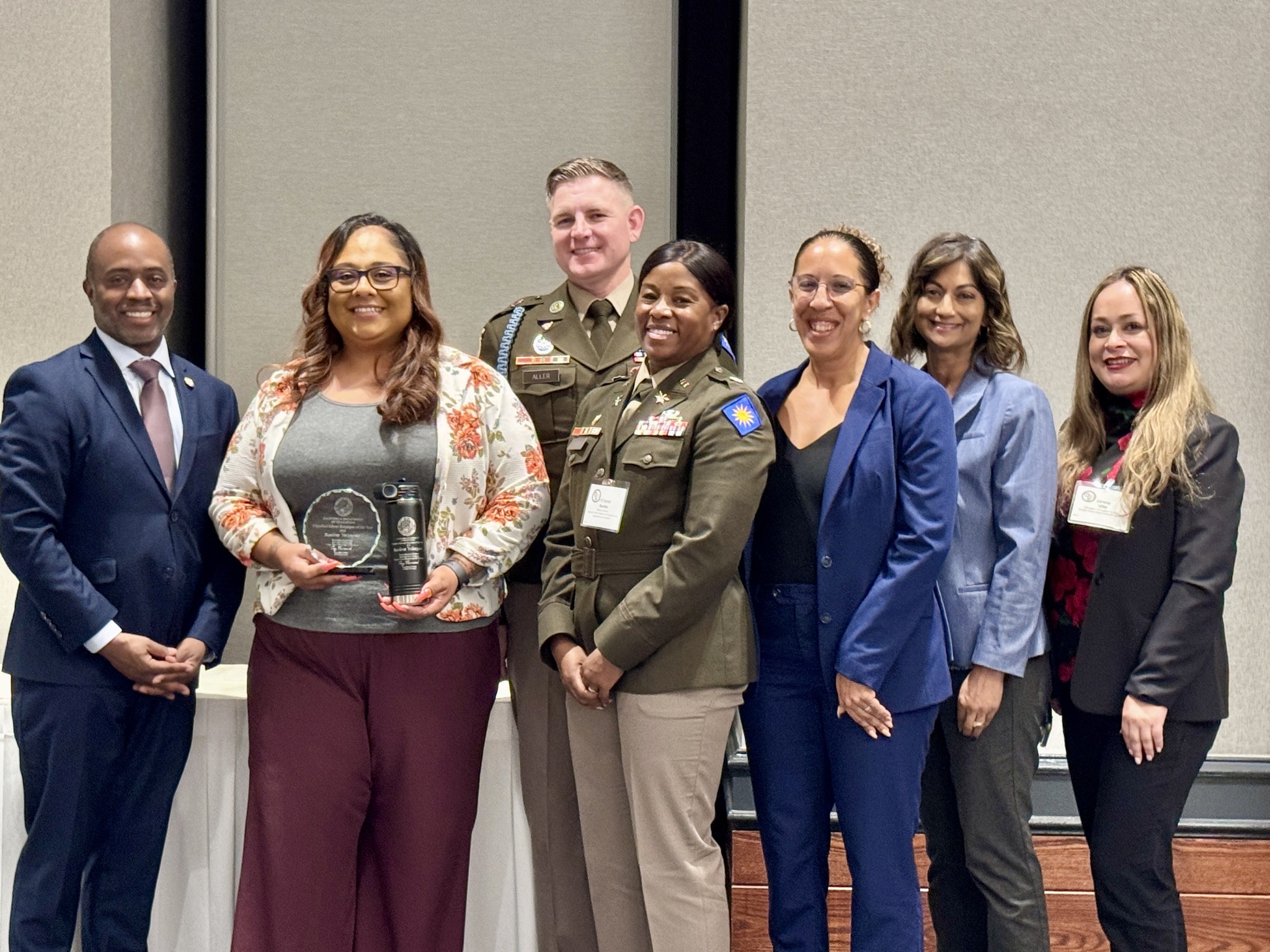 From left, State Superintendent of Public Instruction Tony Thurmond, Raelene Velasquez, Command Sgt. Maj. Richard Aller, Sunburst Youth Academy Director Lt. Col. Sarah Rambo, Principal Dinah Ismail, OCDE Executive Director of Special Education Dr. Amita Cloke and OCDE Manager of Human Resources Support Services Lorena Villa pose for a photo during the 2026 California Classified School Employees of the Year recognition ceremony in Sacramento.