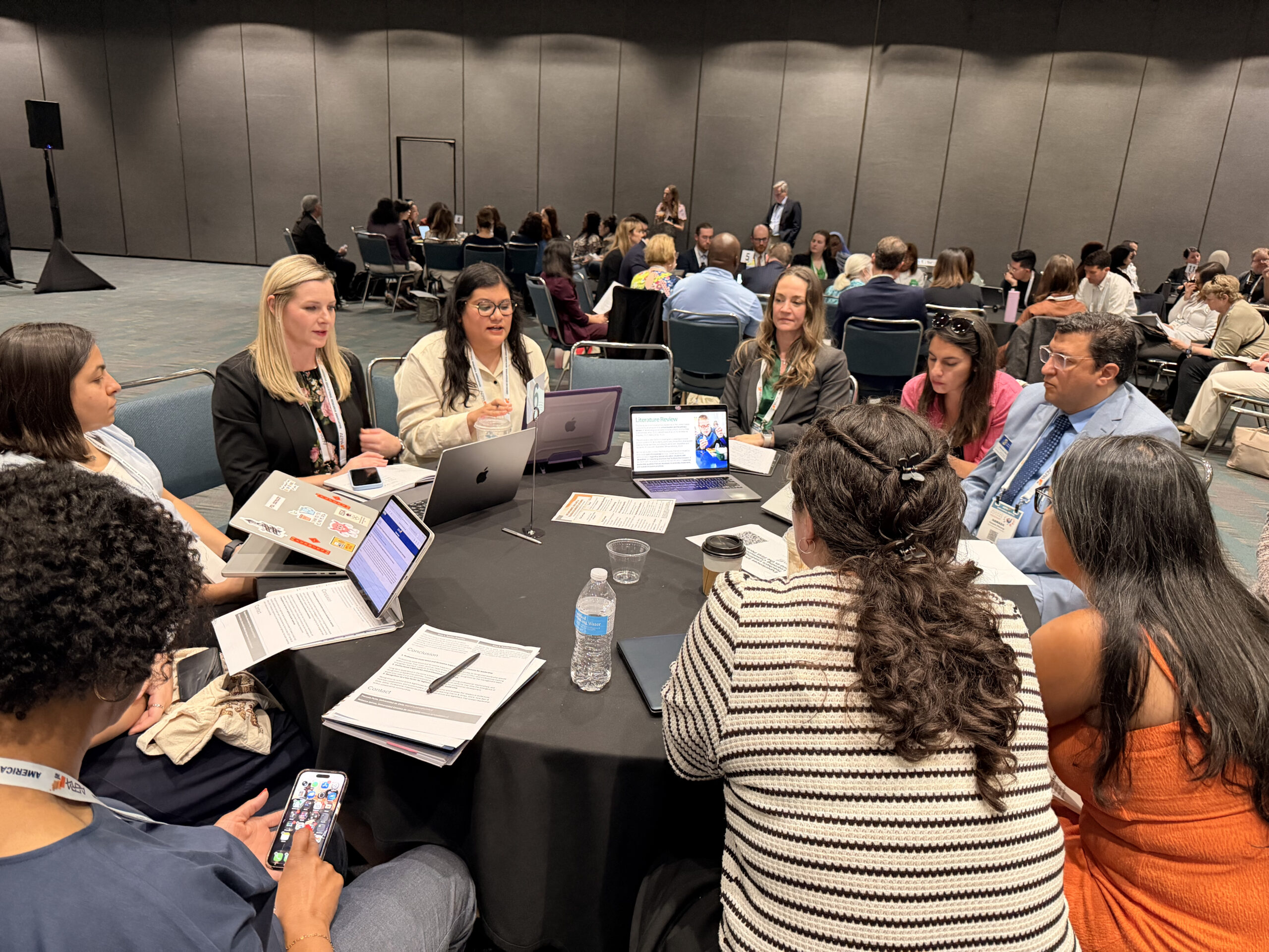 A group of educators and education leaders sit around a conference table during a collaborative discussion session at the 2026 AERA Conference in Los Angeles.