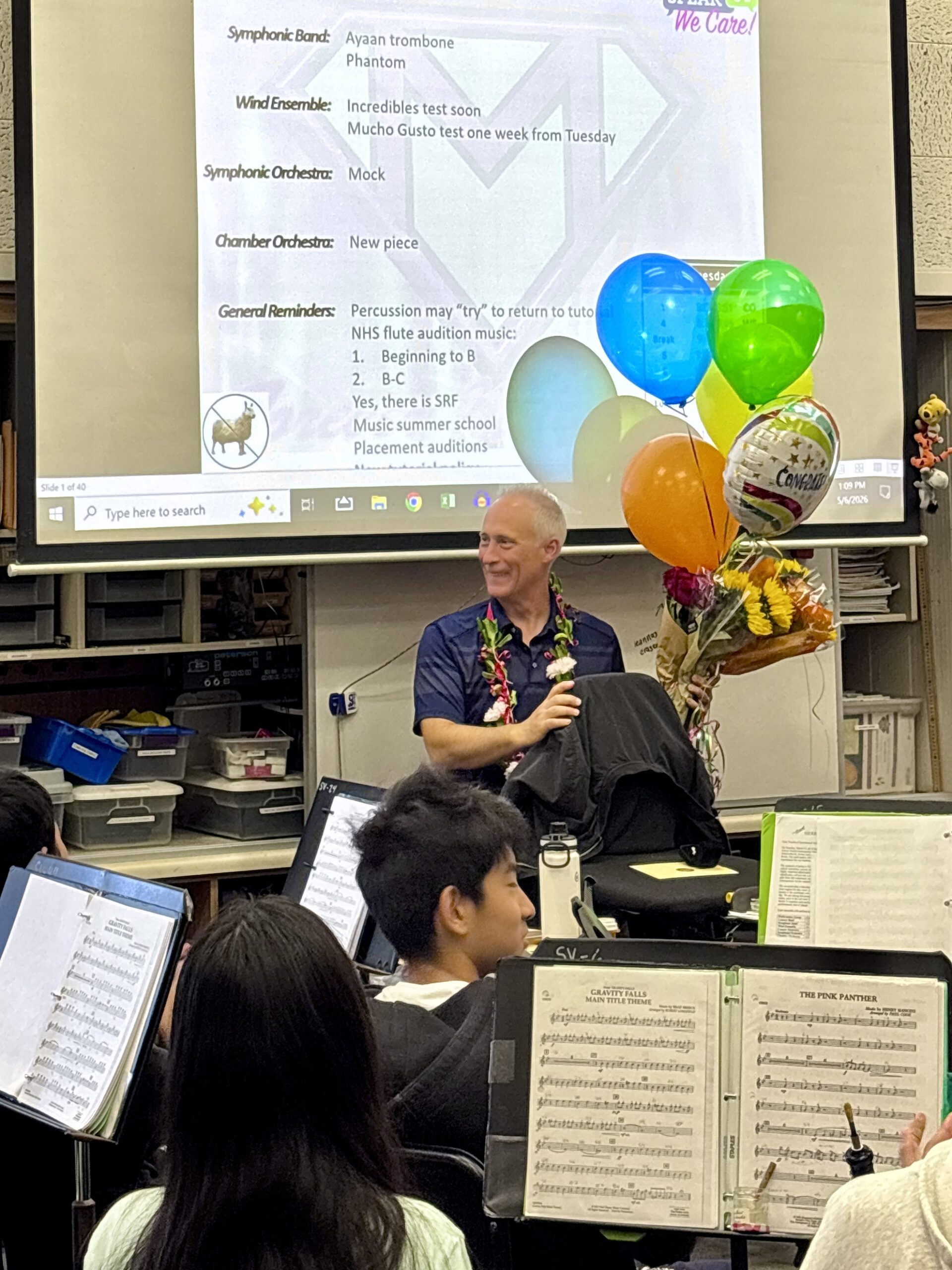 Henry Miller sits in his Sierra Vista Middle School music classroom surrounded by students and colorful congratulatory balloons after being named a 2027 CMA Foundation Music Teacher of Excellence.