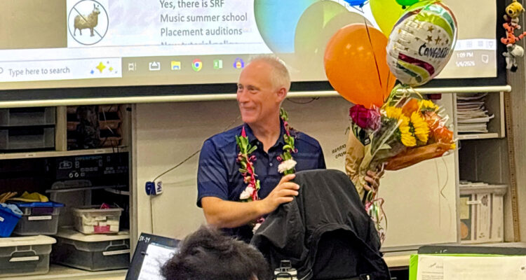 Henry Miller sits in his Sierra Vista Middle School music classroom surrounded by students and colorful congratulatory balloons after being named a 2027 CMA Foundation Music Teacher of Excellence.
