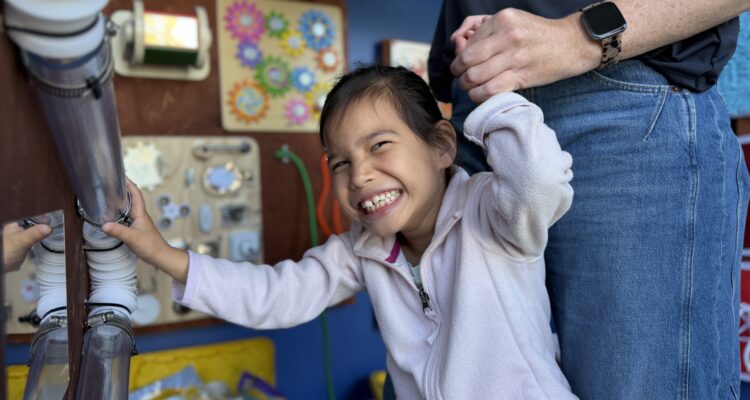 A Hopkinson Elementary School student interacts with a sensory station created by Los Alamitos High School freshman Wesley Avery for the school’s Multi-Aged Huskies classroom.