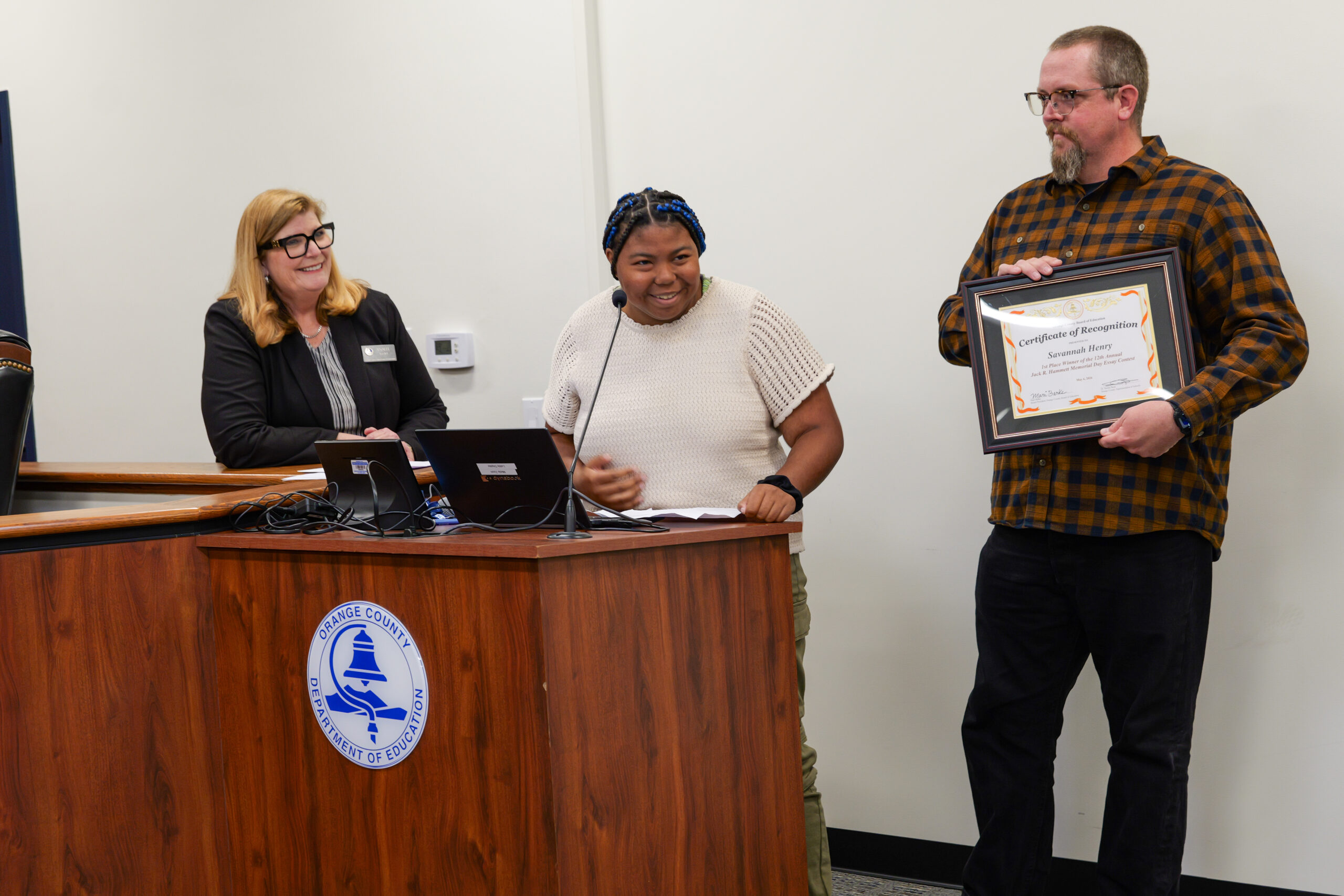 Connections student Savannah read her Memorial Day essay alongside her teacher Dave Van Sutphin and Chief of Connections Analee Kredel. 